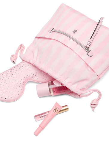 Victoria's Secret siganture stripes cosmetic bag with cosmetic products falling out of it.