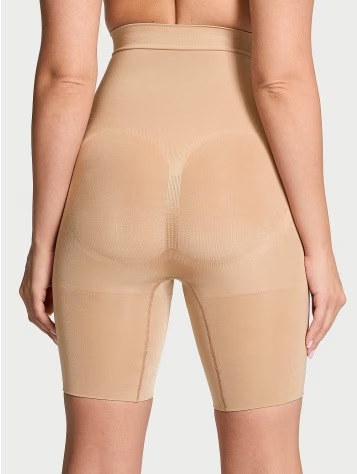 Back view of a woman wearing Victoria's Secret burgundy V-string thong panties