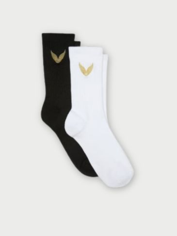 Black and white Victoria's Secret Sport socks with signature golden wings logo on a light grey backround.